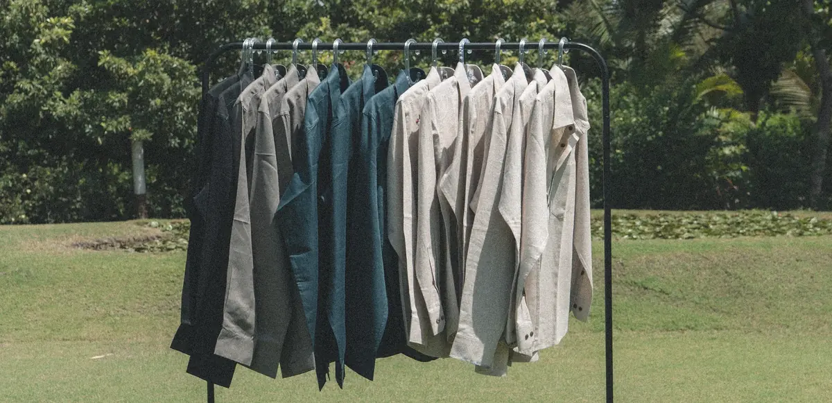 Canndi shirts filed on a rack outdoors
